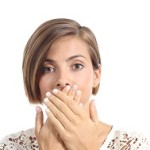 Woman covering her mouth because bad breath isolated on a white background