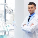 Dentist Doctor Portrait. Young Man at His Workplace. Dental Clinic