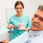 Elderly man on a review of a dentist, sitting in a chair