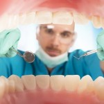 Dentist checks the teeth of a patient