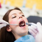 Dentist doing a dental treatment on a female patient